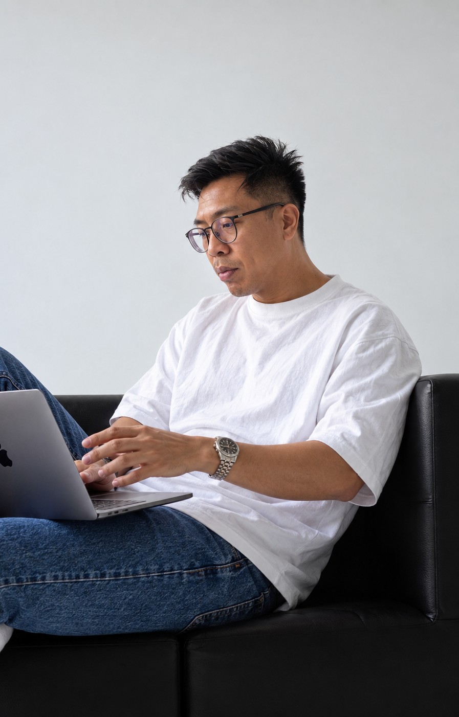 Ben Kittiratanaporn, founder of Witthaya Digital, working on a laptop