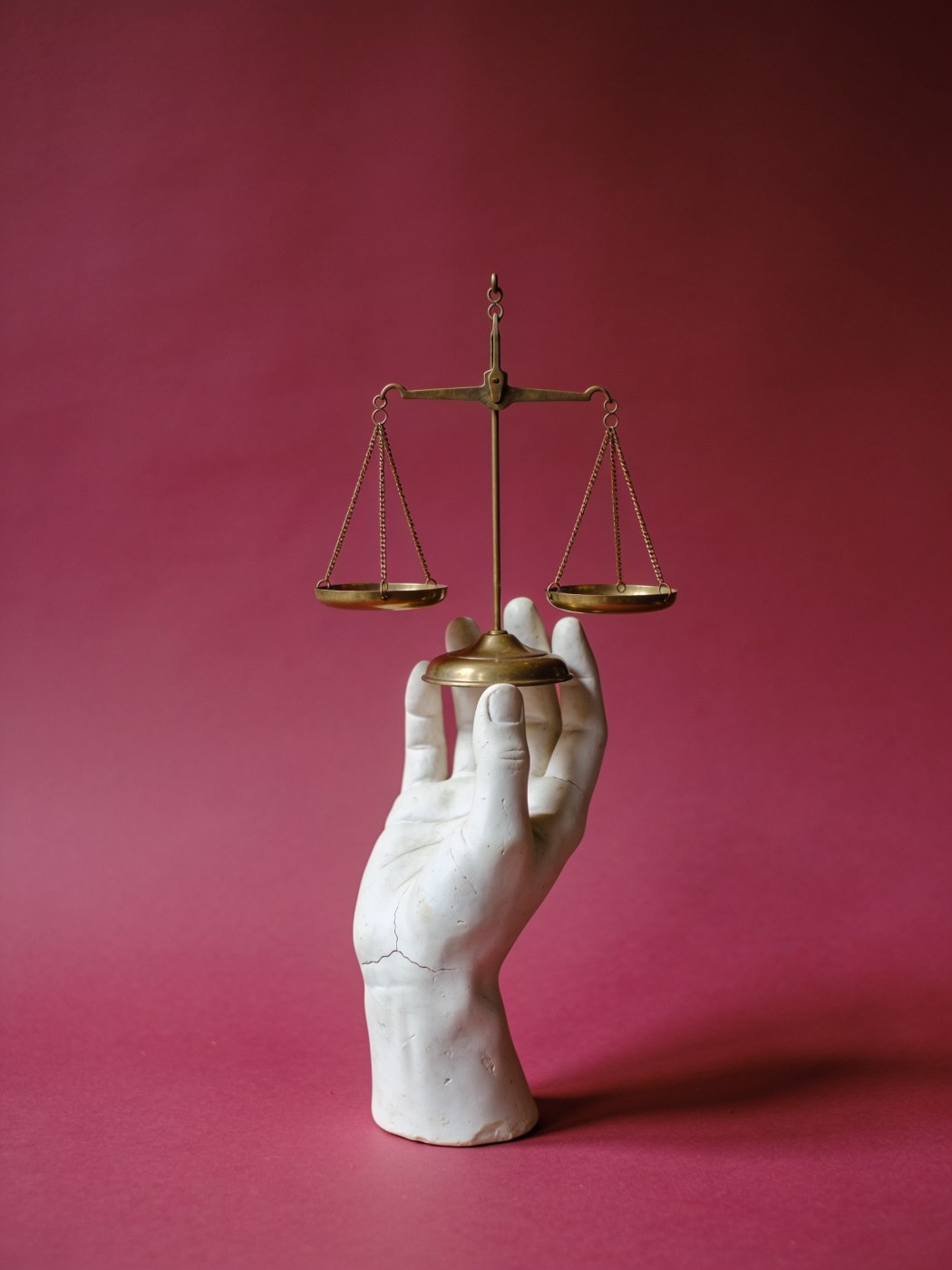 Google Ads conversion tracking: plaster hand holding a balanced brass scale