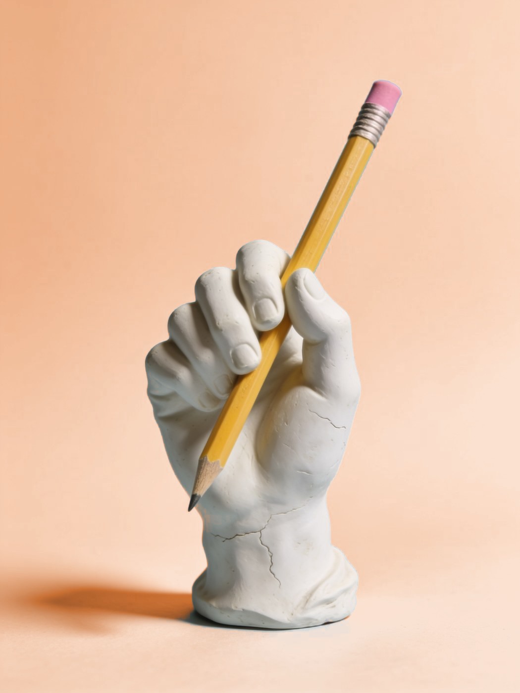 Custom website design: plaster hand holding a pencil